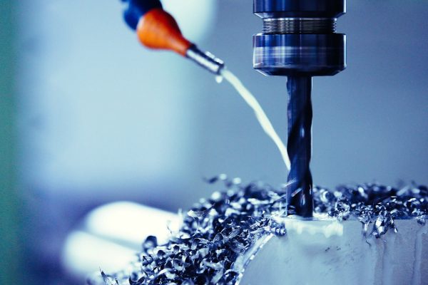 Finishing metal working on high precision grinding machine in workshop Finishing metal working on high precision grinding machine in workshop